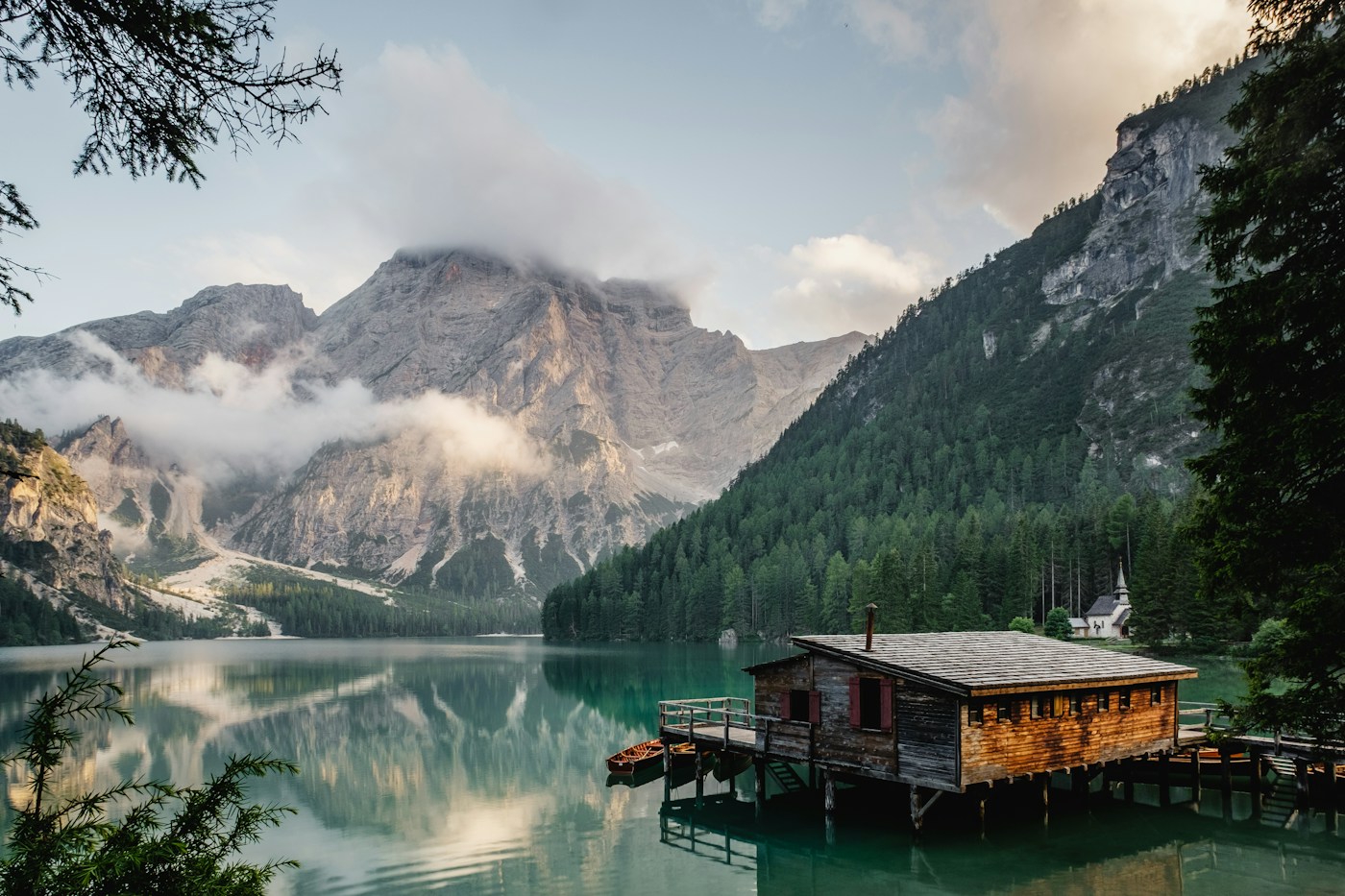 Still lake framed by mountains at dawn